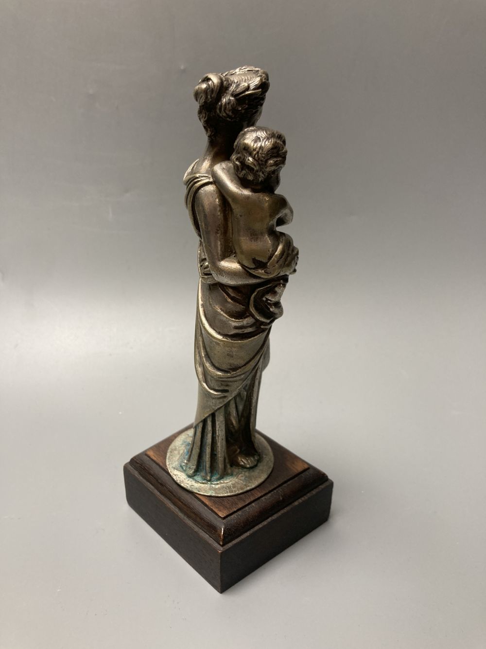 A silvered bronze figure of the Virgin and Mary, height 21cm and a similar tribal African seated gentleman